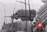 Image of truck lifted to landing craft WW2 France, 1944, second 57 stock footage video 65675079352
