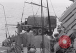 Image of truck lifted to landing craft WW2 France, 1944, second 59 stock footage video 65675079352
