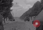 Image of M4 Sherman tank fires in street WW2 Antony France, 1944, second 9 stock footage video 65675079398
