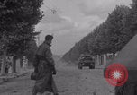 Image of M4 Sherman tank fires in street WW2 Antony France, 1944, second 10 stock footage video 65675079398