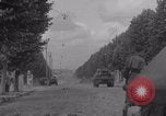 Image of M4 Sherman tank fires in street WW2 Antony France, 1944, second 12 stock footage video 65675079398
