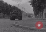 Image of M4 Sherman tank fires in street WW2 Antony France, 1944, second 14 stock footage video 65675079398