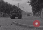 Image of M4 Sherman tank fires in street WW2 Antony France, 1944, second 15 stock footage video 65675079398