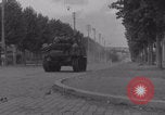 Image of M4 Sherman tank fires in street WW2 Antony France, 1944, second 16 stock footage video 65675079398