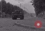 Image of M4 Sherman tank fires in street WW2 Antony France, 1944, second 17 stock footage video 65675079398