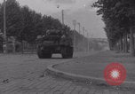 Image of M4 Sherman tank fires in street WW2 Antony France, 1944, second 18 stock footage video 65675079398