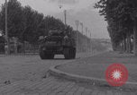 Image of M4 Sherman tank fires in street WW2 Antony France, 1944, second 19 stock footage video 65675079398