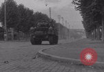 Image of M4 Sherman tank fires in street WW2 Antony France, 1944, second 20 stock footage video 65675079398