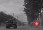 Image of M4 Sherman tank fires in street WW2 Antony France, 1944, second 27 stock footage video 65675079398