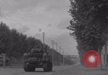 Image of M4 Sherman tank fires in street WW2 Antony France, 1944, second 30 stock footage video 65675079398