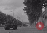 Image of M4 Sherman tank fires in street WW2 Antony France, 1944, second 32 stock footage video 65675079398
