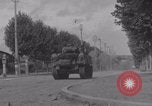 Image of M4 Sherman tank fires in street WW2 Antony France, 1944, second 39 stock footage video 65675079398