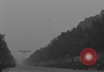 Image of Piper Cub flying Avenue des Champs Elysees Paris France, 1944, second 16 stock footage video 65675079487