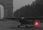 Image of Piper Cub flying Avenue des Champs Elysees Paris France, 1944, second 61 stock footage video 65675079487