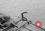 Image of US soldier driving Japanese suicide motorboat Japan, 1945, second 12 stock footage video 65675079539