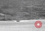 Image of US soldier driving Japanese suicide motorboat Japan, 1945, second 16 stock footage video 65675079539