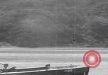 Image of US soldier driving Japanese suicide motorboat Japan, 1945, second 26 stock footage video 65675079539