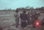 Image of Vietnamese villagers with US soldiers Vietnam, 1967, second 23 stock footage video 65675079546