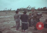 Image of Vietnamese villagers with US soldiers Vietnam, 1967, second 24 stock footage video 65675079546