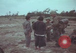 Image of Vietnamese villagers with US soldiers Vietnam, 1967, second 25 stock footage video 65675079546