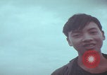 Image of Vietnamese villagers with US soldiers Vietnam, 1967, second 56 stock footage video 65675079546
