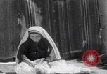 Image of mother wraps baby in swaddle Bethlehem Palestine, 1941, second 31 stock footage video 65675079605
