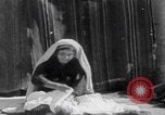 Image of mother wraps baby in swaddle Bethlehem Palestine, 1941, second 32 stock footage video 65675079605