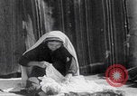 Image of mother wraps baby in swaddle Bethlehem Palestine, 1941, second 34 stock footage video 65675079605