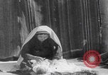 Image of mother wraps baby in swaddle Bethlehem Palestine, 1941, second 35 stock footage video 65675079605