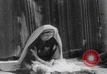 Image of mother wraps baby in swaddle Bethlehem Palestine, 1941, second 36 stock footage video 65675079605