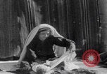 Image of mother wraps baby in swaddle Bethlehem Palestine, 1941, second 37 stock footage video 65675079605