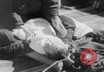 Image of mother wraps baby in swaddle Bethlehem Palestine, 1941, second 39 stock footage video 65675079605