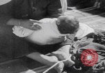 Image of mother wraps baby in swaddle Bethlehem Palestine, 1941, second 40 stock footage video 65675079605