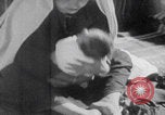 Image of mother wraps baby in swaddle Bethlehem Palestine, 1941, second 41 stock footage video 65675079605