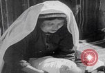Image of mother wraps baby in swaddle Bethlehem Palestine, 1941, second 42 stock footage video 65675079605