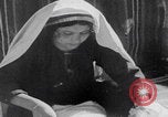 Image of mother wraps baby in swaddle Bethlehem Palestine, 1941, second 43 stock footage video 65675079605
