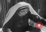 Image of mother wraps baby in swaddle Bethlehem Palestine, 1941, second 44 stock footage video 65675079605