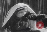 Image of mother wraps baby in swaddle Bethlehem Palestine, 1941, second 45 stock footage video 65675079605