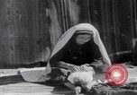 Image of mother wraps baby in swaddle Bethlehem Palestine, 1941, second 47 stock footage video 65675079605