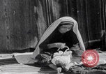 Image of mother wraps baby in swaddle Bethlehem Palestine, 1941, second 49 stock footage video 65675079605