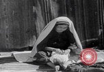 Image of mother wraps baby in swaddle Bethlehem Palestine, 1941, second 50 stock footage video 65675079605