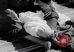 Image of mother wraps baby in swaddle Bethlehem Palestine, 1941, second 55 stock footage video 65675079605