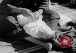 Image of mother wraps baby in swaddle Bethlehem Palestine, 1941, second 56 stock footage video 65675079605