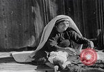 Image of mother wraps baby in swaddle Bethlehem Palestine, 1941, second 62 stock footage video 65675079605