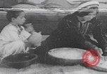 Image of Palestinian boy and mother making bread Palestine, 1941, second 1 stock footage video 65675079606