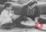 Image of Palestinian boy and mother making bread Palestine, 1941, second 3 stock footage video 65675079606