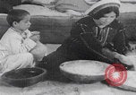 Image of Palestinian boy and mother making bread Palestine, 1941, second 4 stock footage video 65675079606