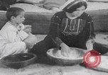 Image of Palestinian boy and mother making bread Palestine, 1941, second 5 stock footage video 65675079606