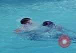 Image of men splashing swimming pool Las Vegas Nevada USA, 1967, second 7 stock footage video 65675079700