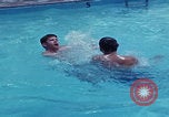 Image of men splashing swimming pool Las Vegas Nevada USA, 1967, second 8 stock footage video 65675079700